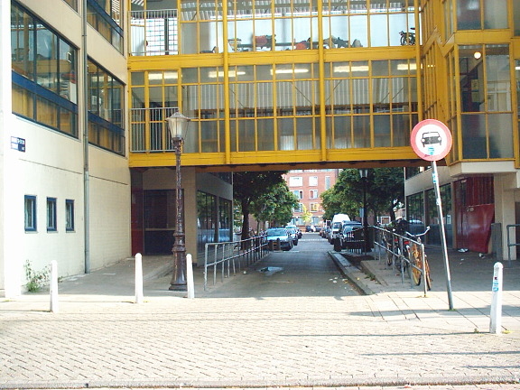  Op de plaats van de gesloopte poortwoningen kwam een buurthuis, de huiskamer van de straat. De moderne Danie Theronstraat, 2003 - De nieuwe poort: de sfeer van vroeger is weg. 